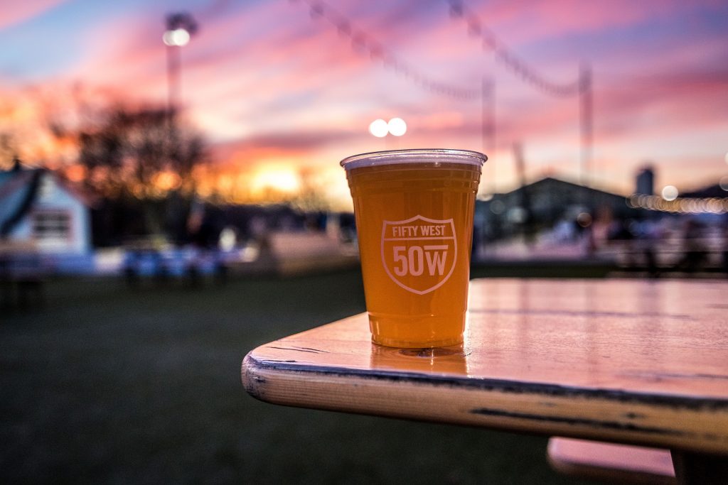 50 West brewery cup of beer with sunset is a top place for a beer in cincinnati