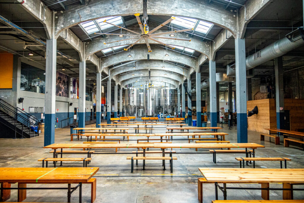 Interior view of the Rhinegeist taproom with tables and benches